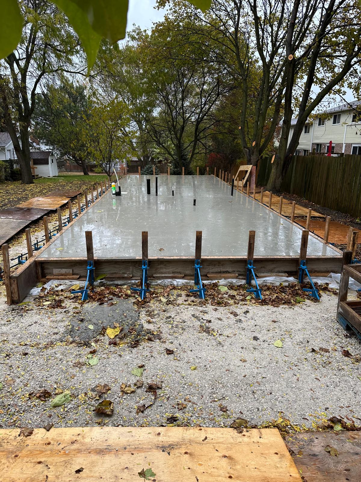 Concrete foundation with anchor bolts and forms ready for SIP panel wall installation