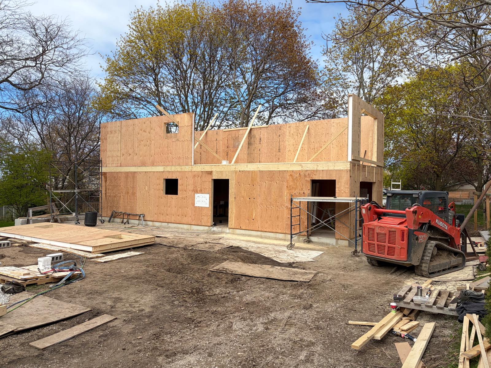 Two-story SIP panel home under construction with walls complete and ready for roof installation