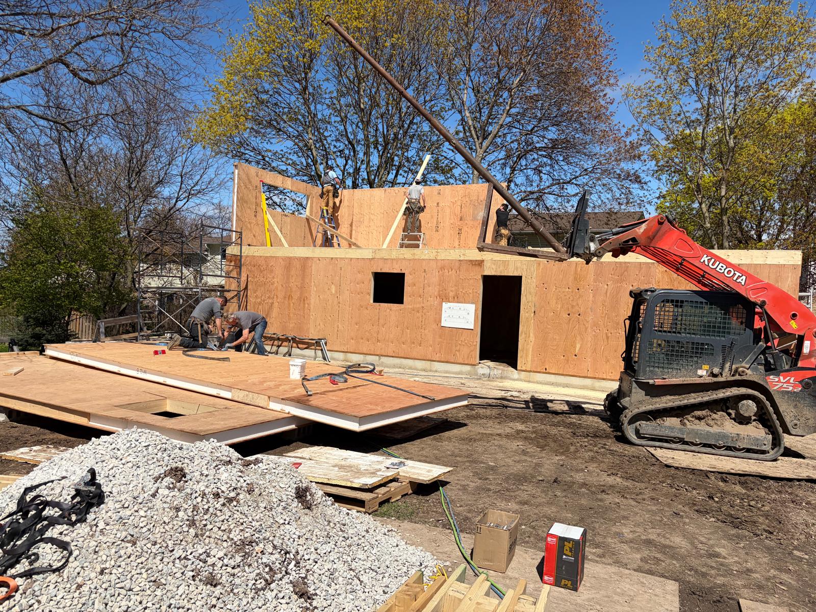 Exterior view of SIP panel home with all walls erected showing door and window openings